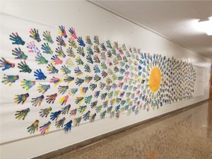 Image of Roylco Color Diffusing Hands artwork display on school hallway