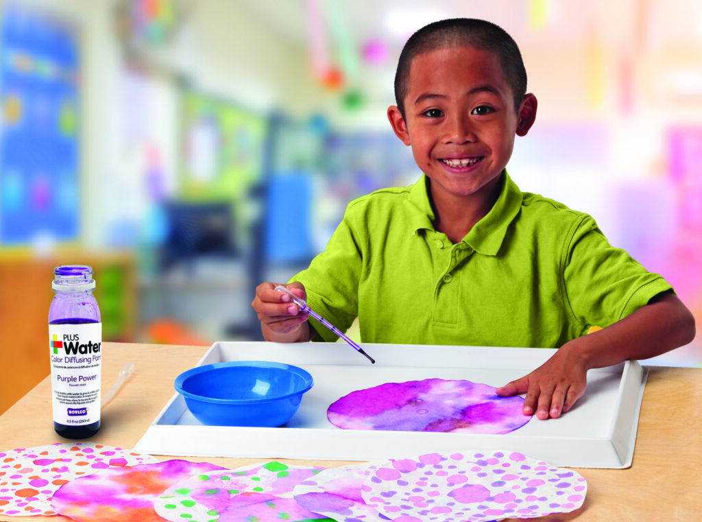 Little boy using paint to create art on color diffusing pages, colorful artwork, using paint to create watercolor art, purple art, pink art, young boy creating art