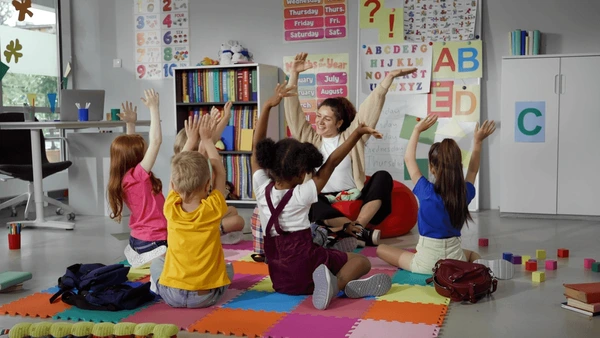 Preschool teacher engaging in class and making movement.